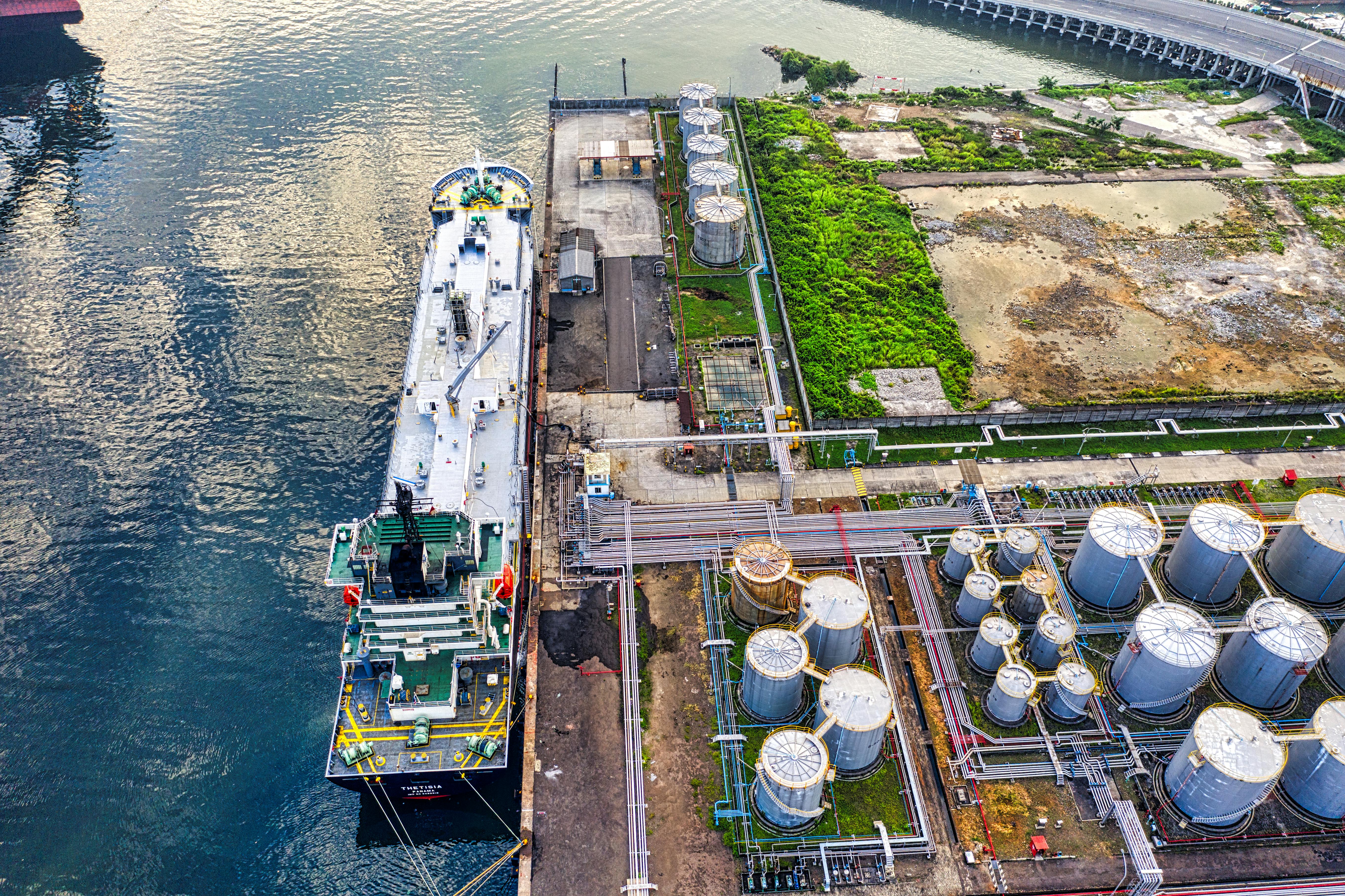 pexels-photo-3840446-3840446 Aerial view of a ship docking at an industrial port with storage tanks in North Jakarta.